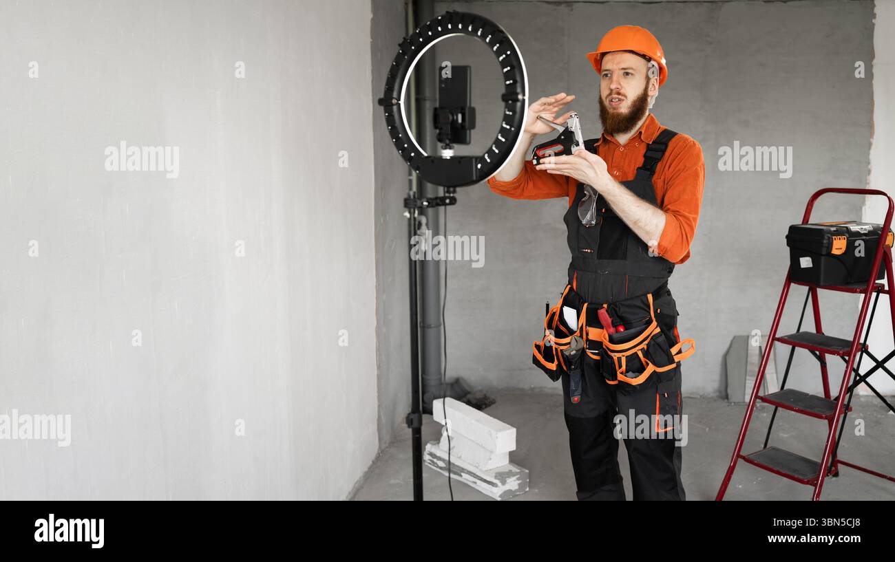 Handyman Broadcasting Construction Tips and Tricks During Home Project. Banner. Copy space Stock Photo