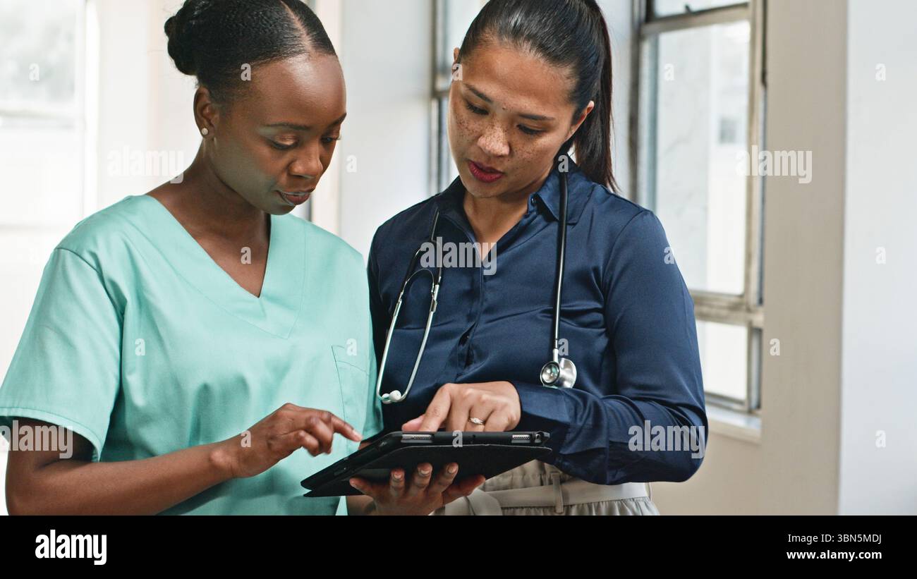 Healthcare Professionals Collaborating Using Digital Technology in a Clinical Setting Stock Photo