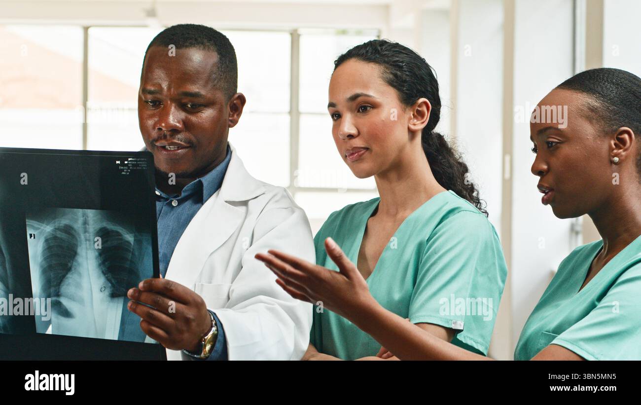 Diverse Medical Professionals Collaborating on X-Ray Analysis in Modern ...