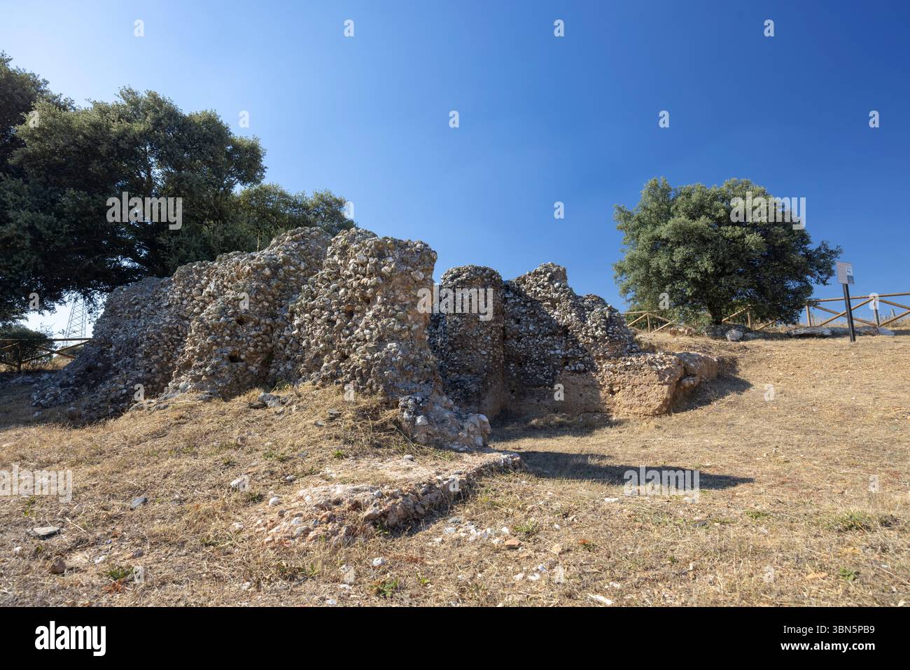 Low walls made of rocks and concrete are all that remain of the ancient ...