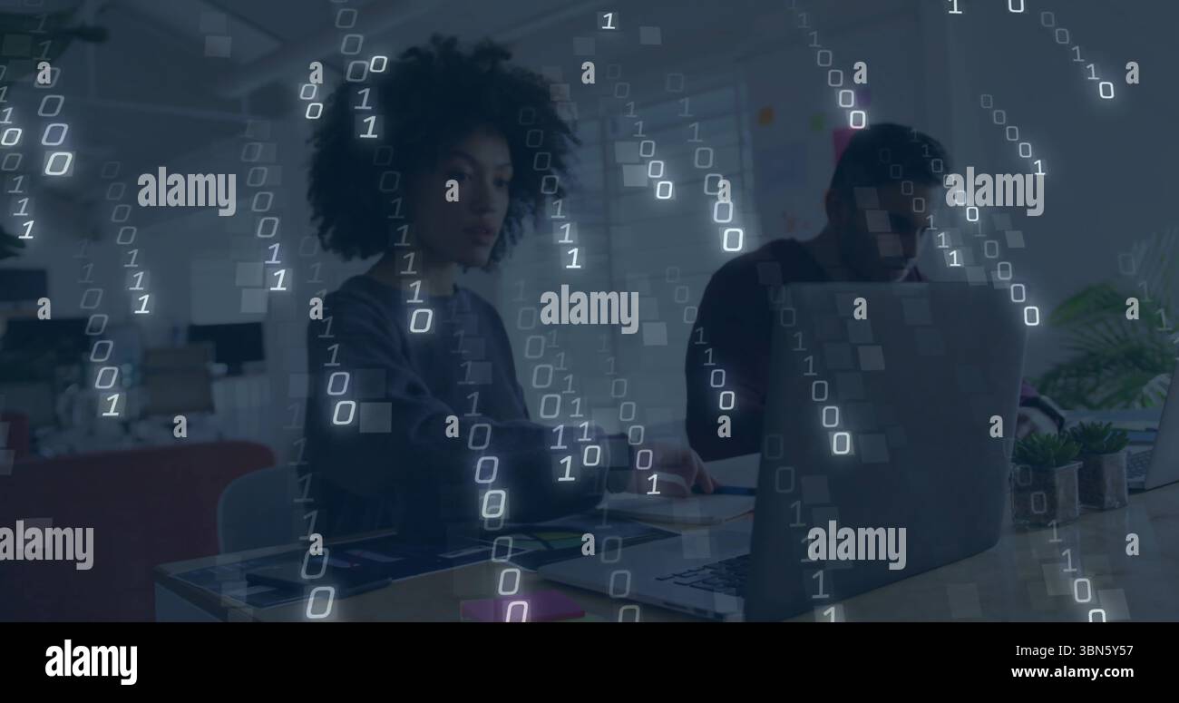 Binary code image over diverse people working on laptops in office Stock Photo
