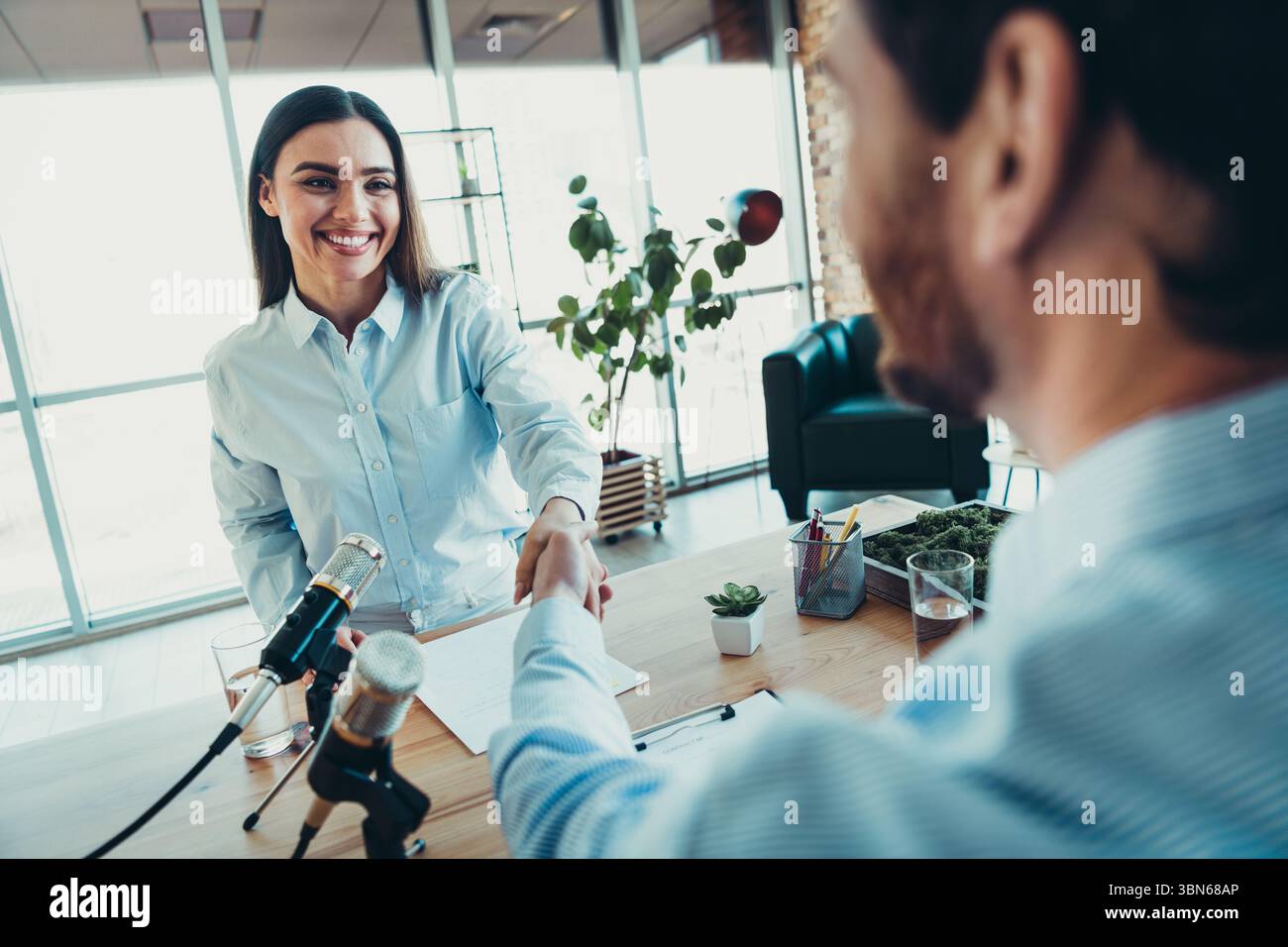 Professional handshake during an office interview showcasing teamwork ...