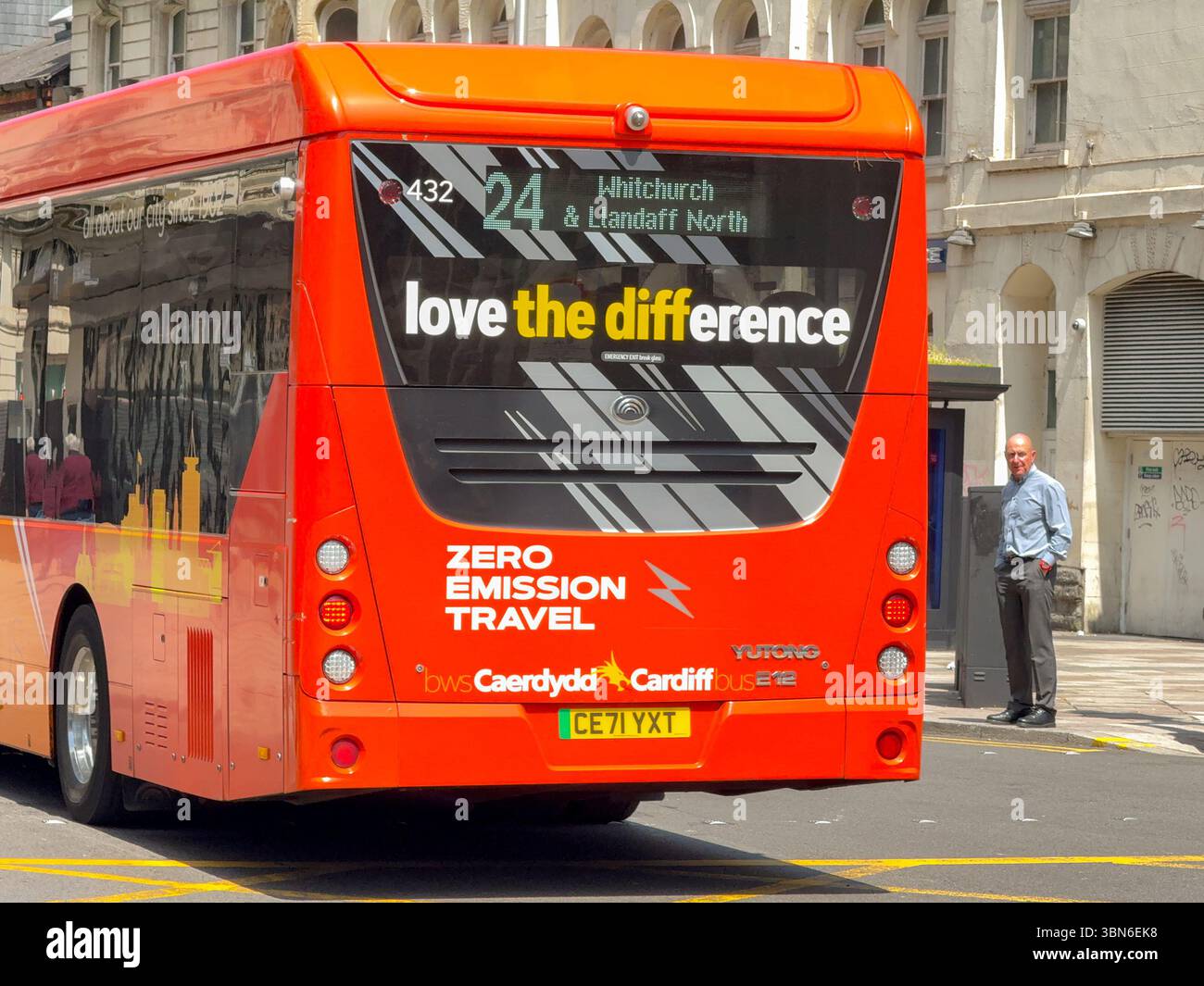 Cardiff, Wales, UK - 18 June 2025: Single deck electric bus operated by Cardiff Bus driving on a road in Cardiff city centre, bilingual, - Smartphone Captured Stock Image
