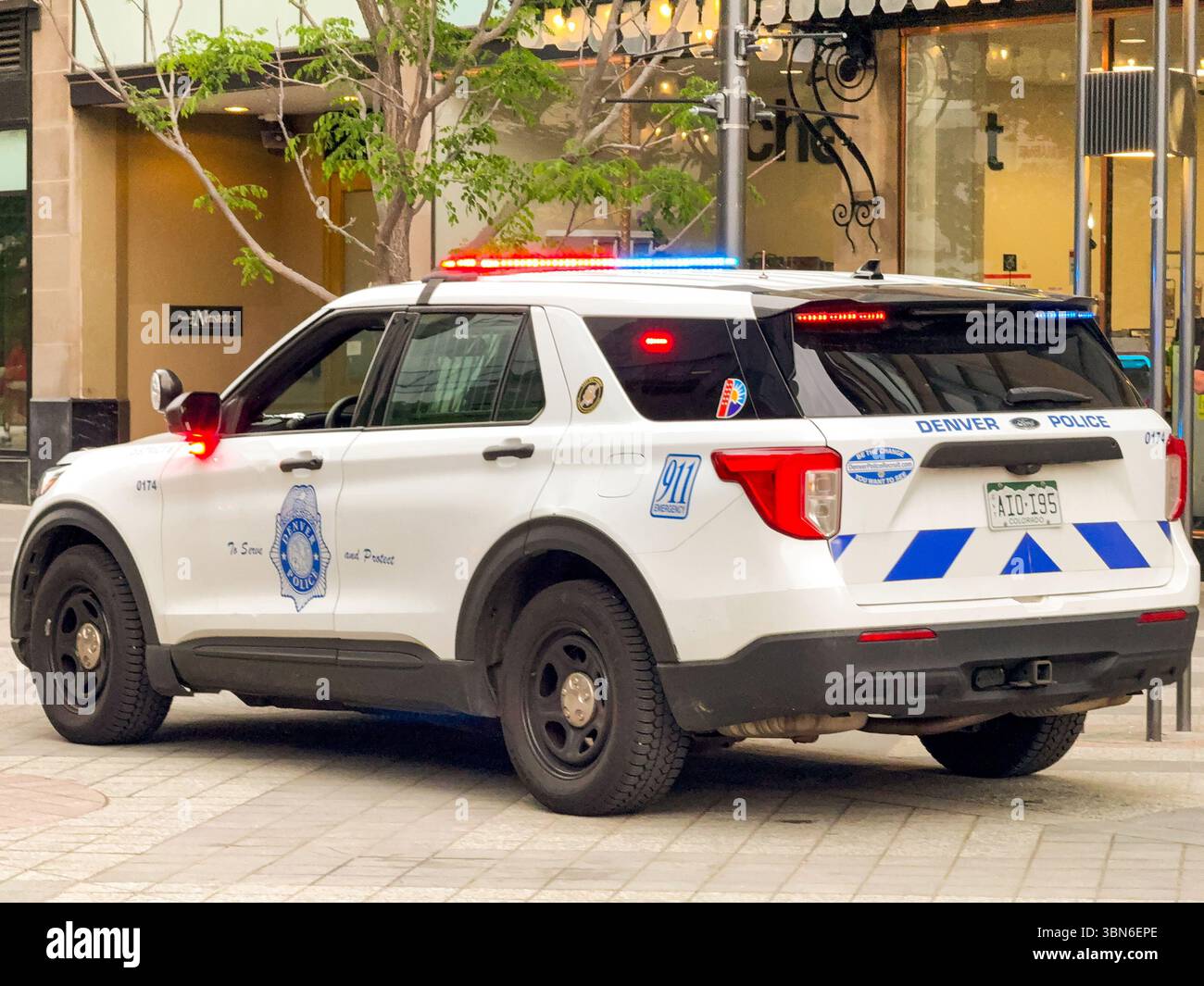 Denver, Colorado, USA - 2 June 2025: Police patrol car of the Denver Police Department with flashing blue and red lights on patrol in the city centre. - Smartphone Captured Stock Image