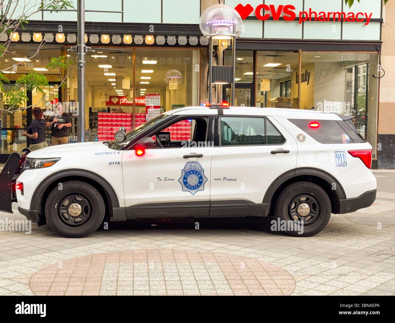 Denver, Colorado, USA - 2 June 2025: Police patrol car of the Denver Police Department with flashing lights on patrol in the city centre. - Smartphone Captured Stock Image
