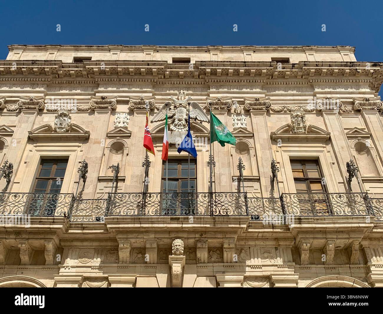 A close-up view of the ornate facade of Palazzo Vermexio in Ortigia, Syracuse-a beautiful example of Baroque architecture, rich in detail and character. Stock Photo