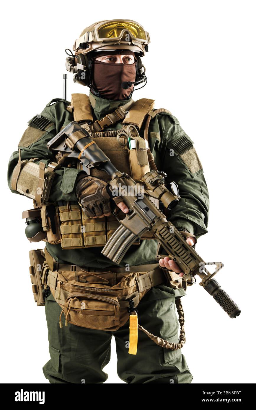 A military personnel dressed in tactical gear, equipped with a firearm ...