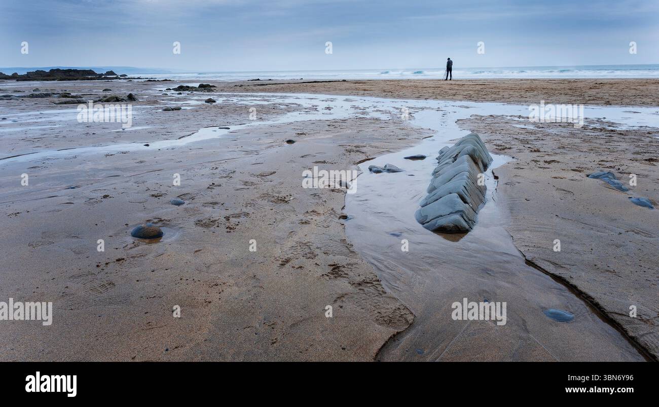 a lone person at Sandymouth bay, Cornwall, England, UK Stock Photo