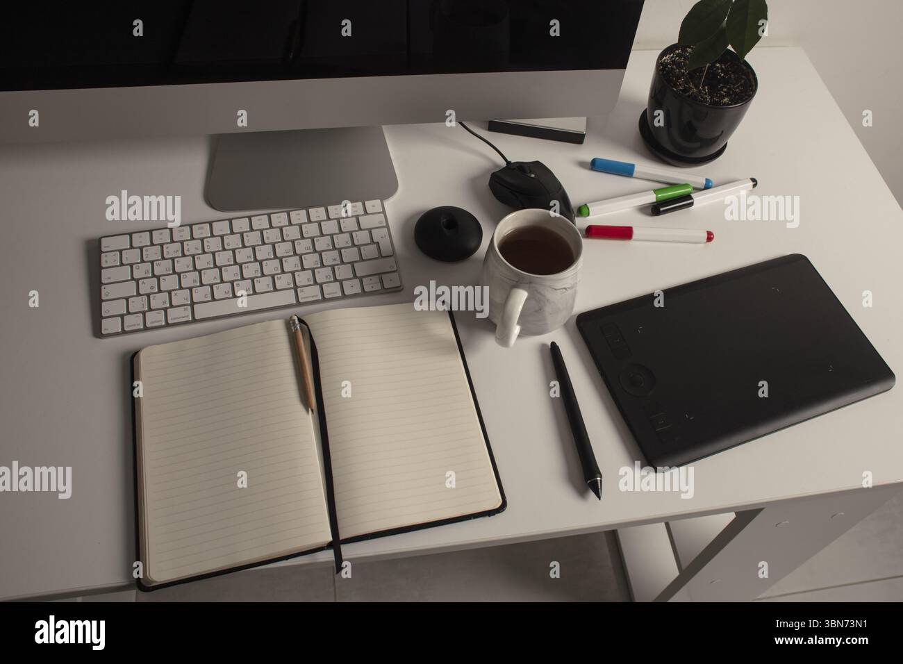 Minimalist home office workspace with a desktop computer, keyboard ...