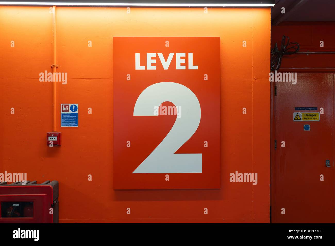 A giant red Level 2 sign in the Oracle public car park, Reading, UK. Concept: level two, number two, second floor, secondly, car parking level Stock Photo