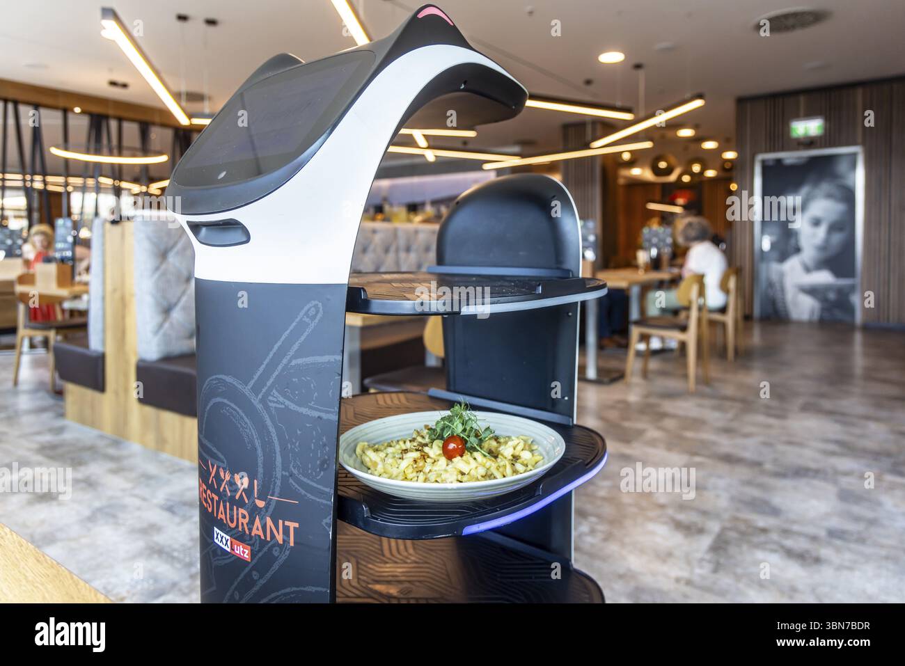 Furniture store XXXLutz Mann Mobilia Karlsruhe. In the restaurant, serving robot Lutzi supports the staff and brings the food to the table. Karlsruhe Stock Photo