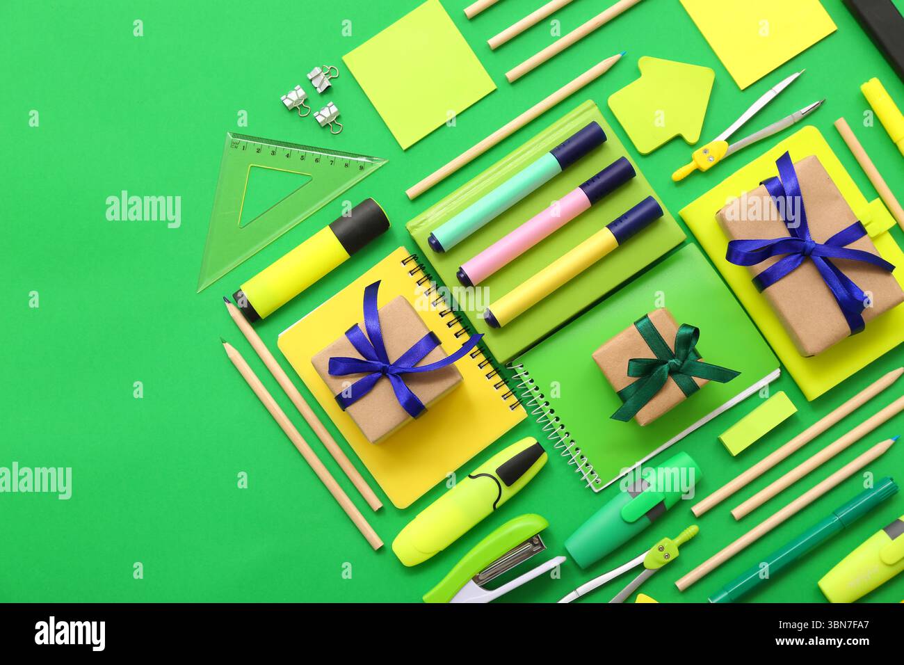 Gift boxes with different stationery on green background Stock Photo