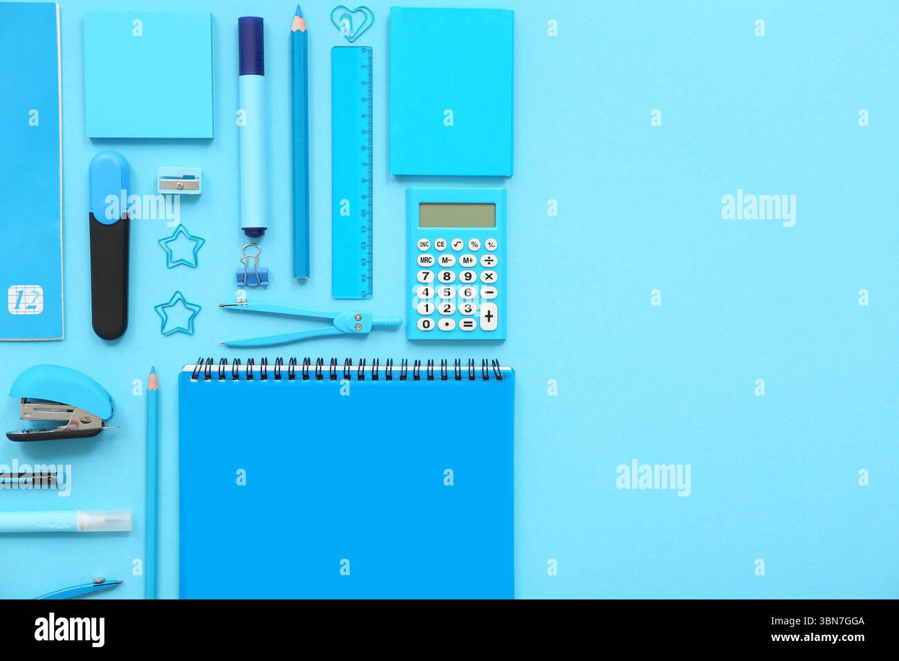 Composition with notebooks and different stationery on blue background Stock Photo