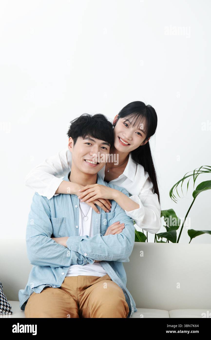 Young couple embracing on the sofa Stock Photo