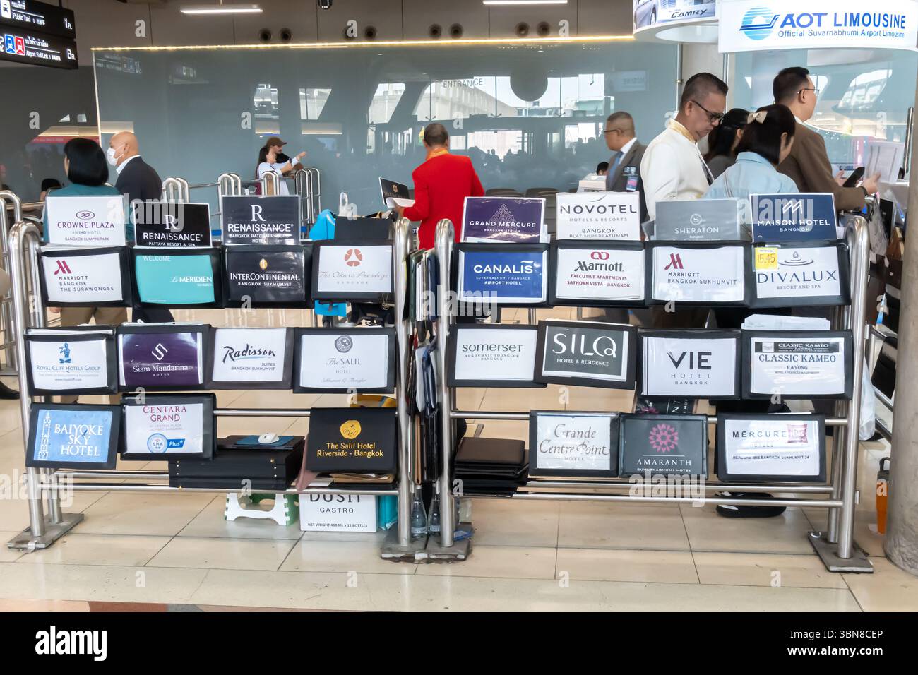Hotel signs indicating the transfer service to major hotel brands at arrivals terminal, Bangkok airport, Thailand Stock Photo