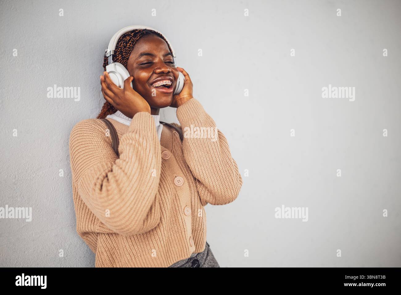 Portrait of young black woman who is messaging on smartphone. Stock Photo
