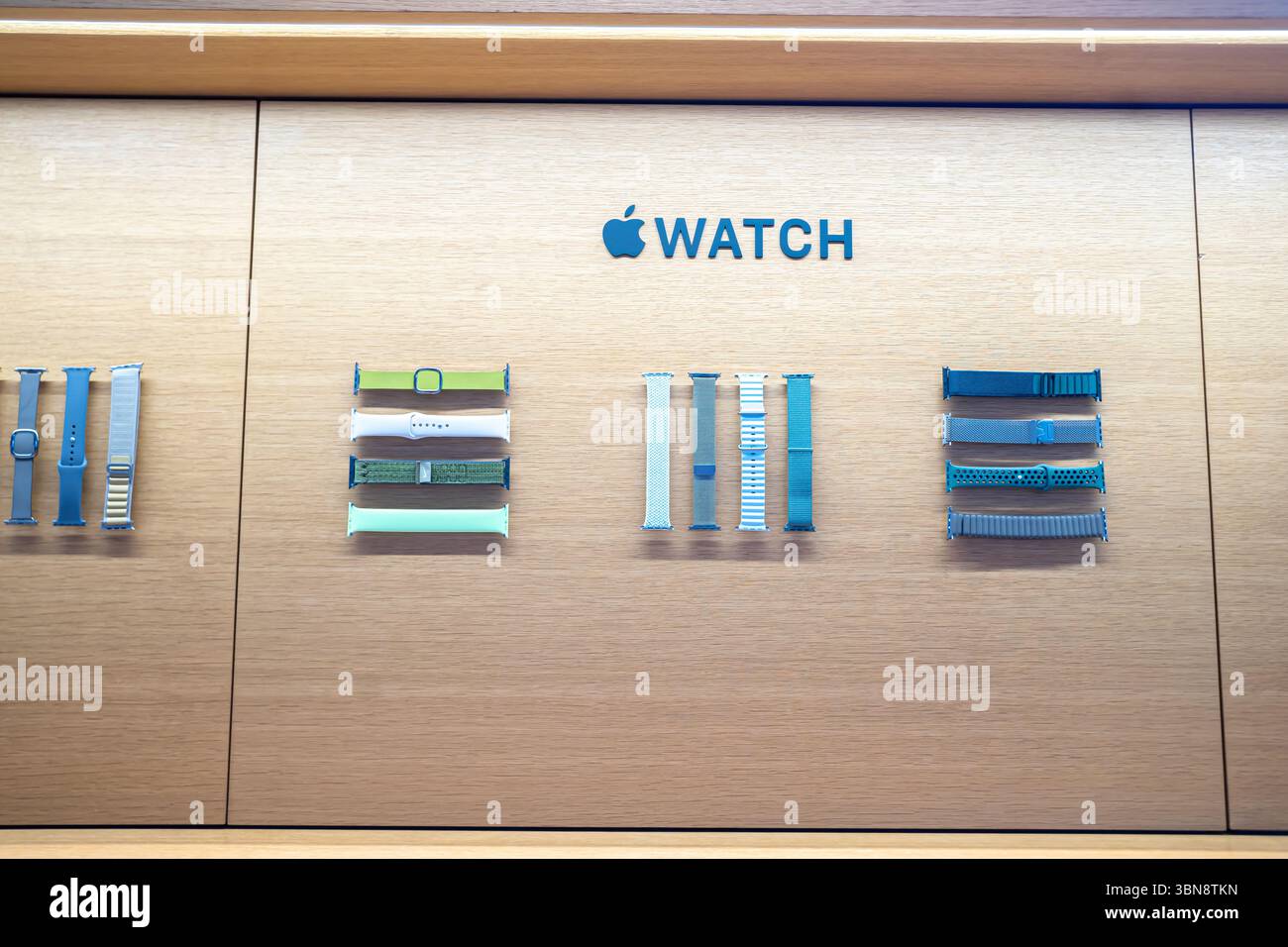 Apple Watch bands are displayed on a wall under the Apple Watch logo. Apple Central World, Bangkok, Thailand Stock Photo