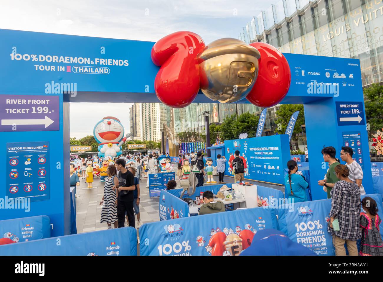 A crowd of people is gathered at the entrance of a 