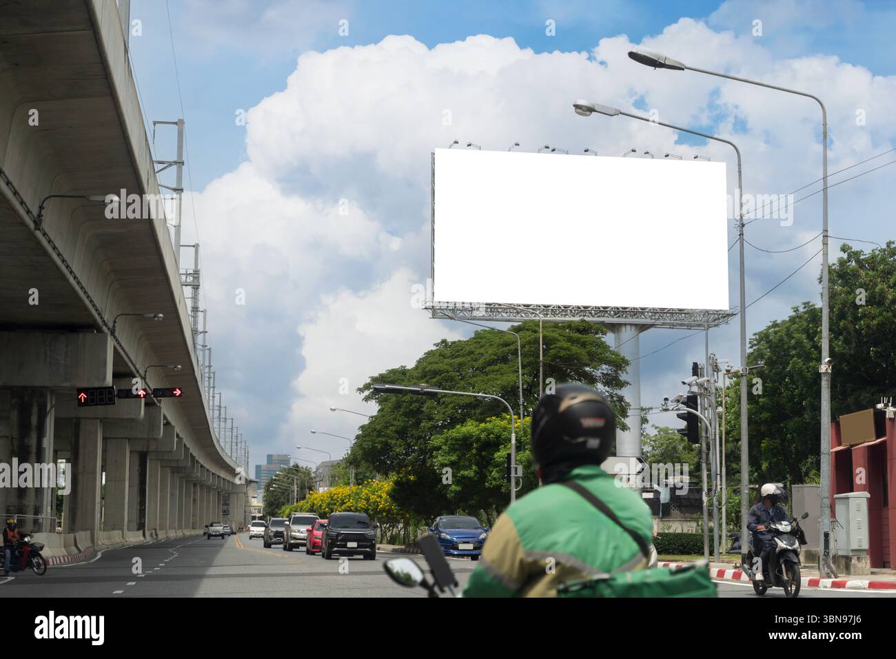 Empty billboard above a busy road in the city with traffic, motorbikes ...