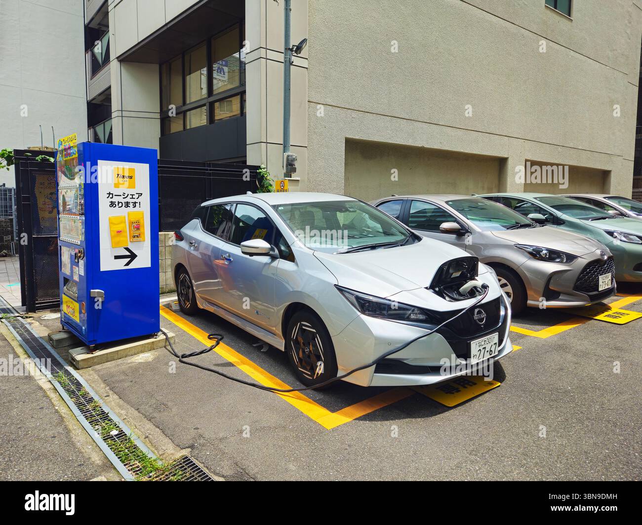 Electric Nissan Leaf Charging at Osaka Street Car-Share Spot Stock Photo