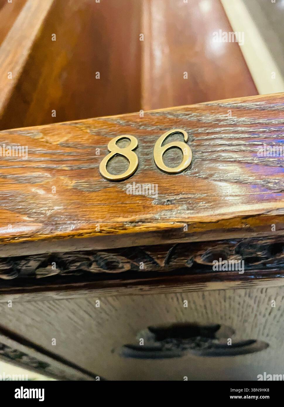 Brass pew number 86 in St. Patrick's Cathedral on Fifth Avenue, 2025, New York City, USA - Smartphone Captured Stock Image