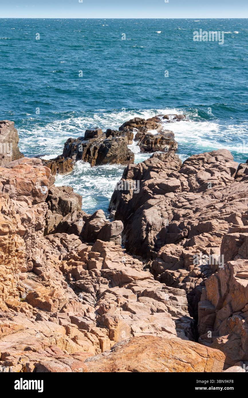 landscape of sea coast with rock in summer. wonderful weekend getaway in europe. textured coastline with blue sky above horizon Stock Photo