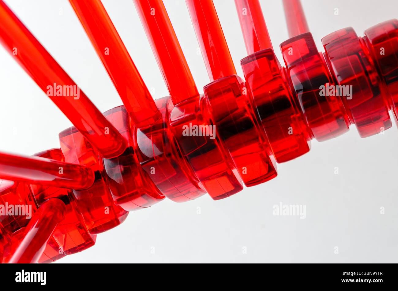 Extreme close-up of a series of red rods on a shaft in a rotating ...
