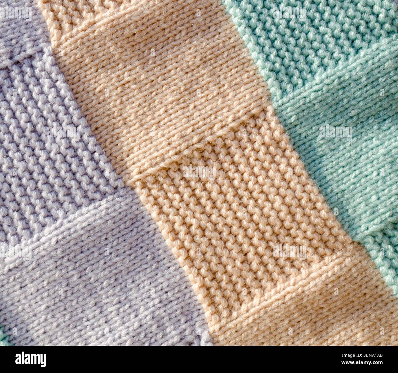 Knitting, handwork. Garter stitch pattern from wool yarn. Pattern for a ...