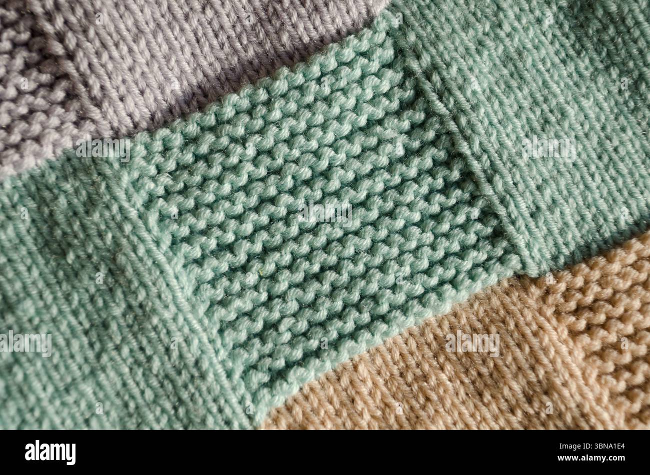 Knitting, handwork. Garter stitch pattern from wool yarn. Pattern for a ...