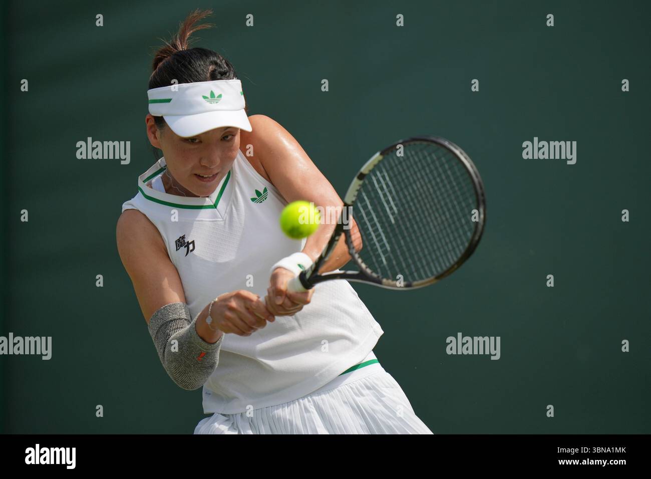 Wang Xinyu of China returns to Karolina Muchova of Czech Republic