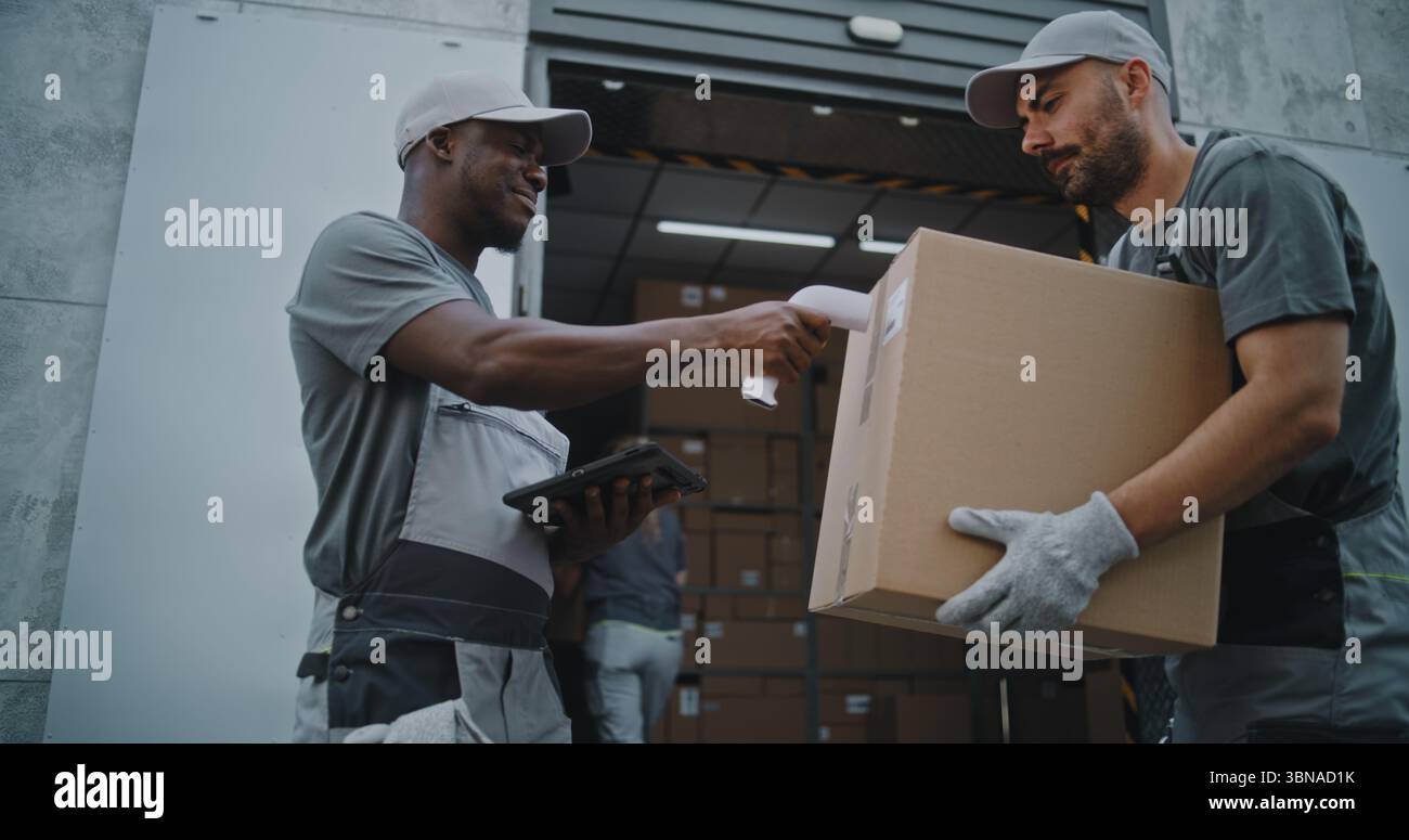 Diverse workers taking cardboard boxes hi-res stock photography and ...