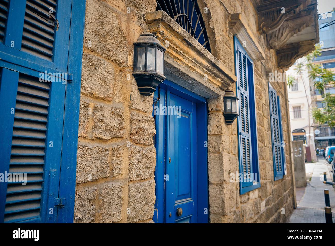 Rustic stone building with blue door and shuttered window Stock Photo ...