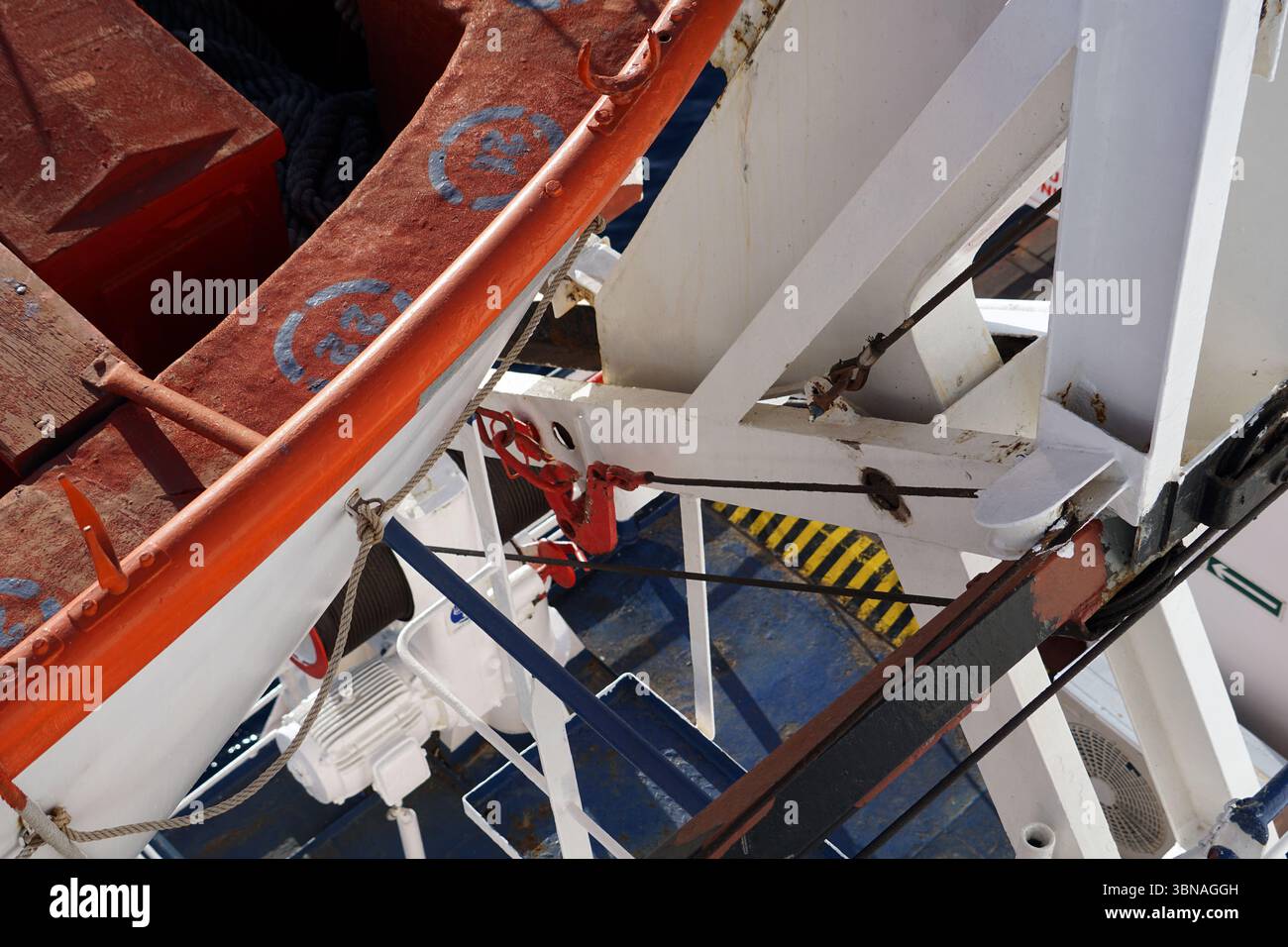 A section of a ship's deck, featuring a white metal structure with a ...