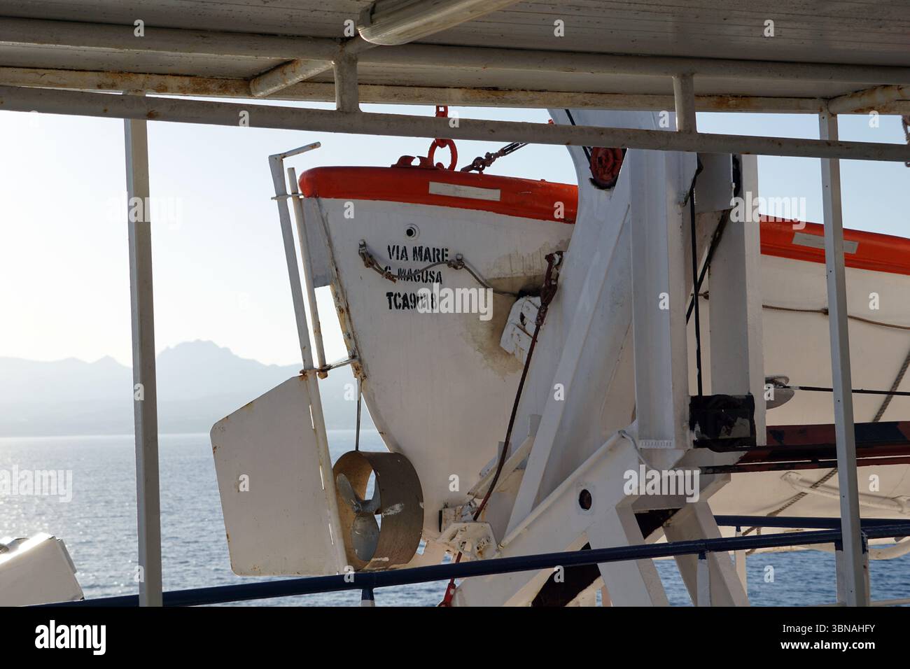 A white and orange lifeboat, labeled
