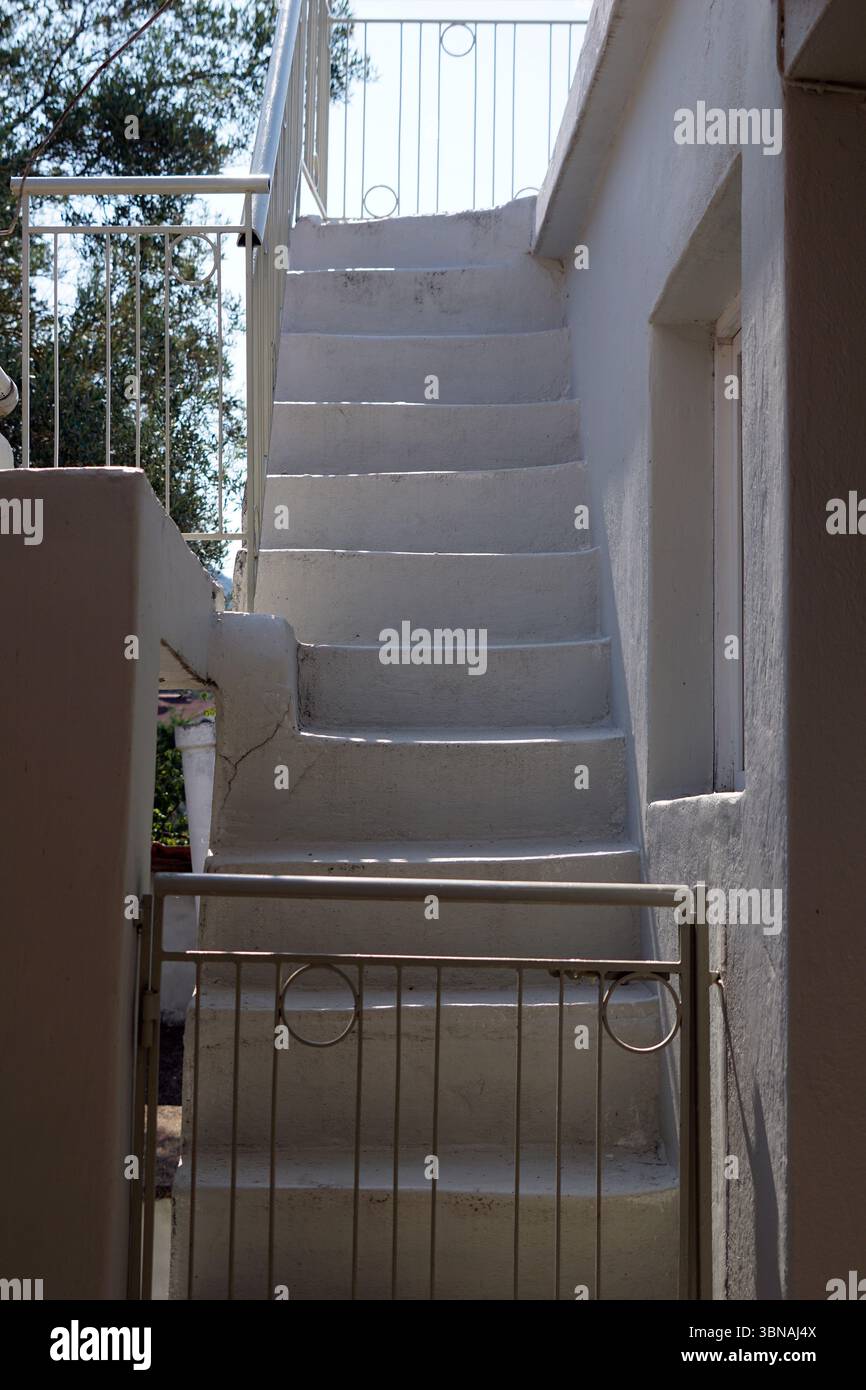 Greek village life, A white staircase with a metal railing, leading ...