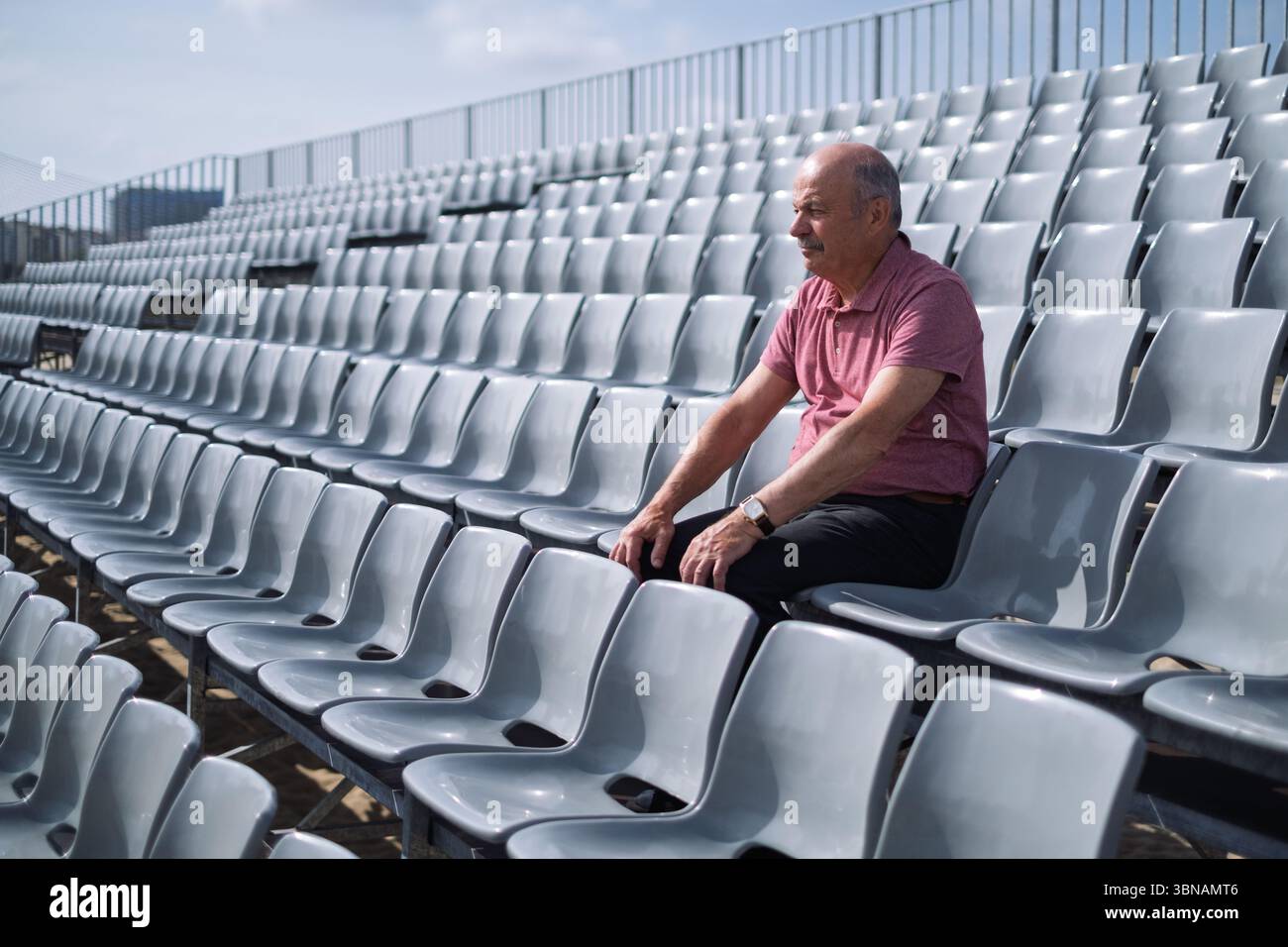 Elderly Spanish Man Sitting Alone on Stadium Stands Feeling Sad Stock Photo