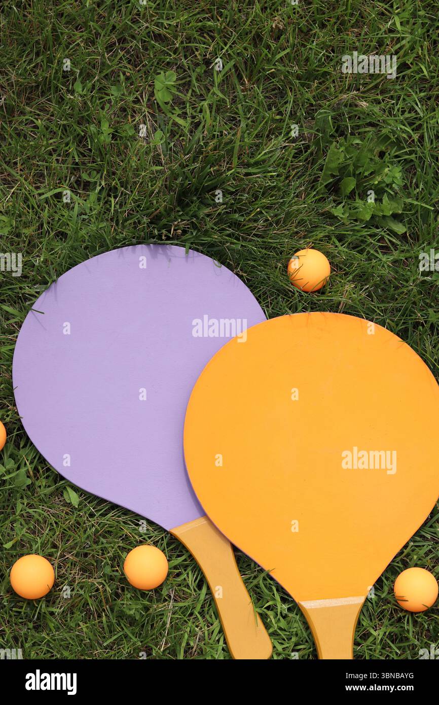 Beach tennis rackets and ball on grass, top view. Beach tennis set ...