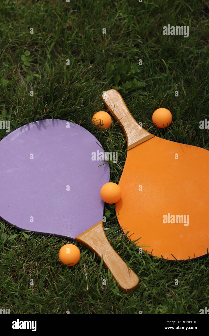 Beach tennis rackets and ball on grass. Beach tennis set. Bright wooden ...