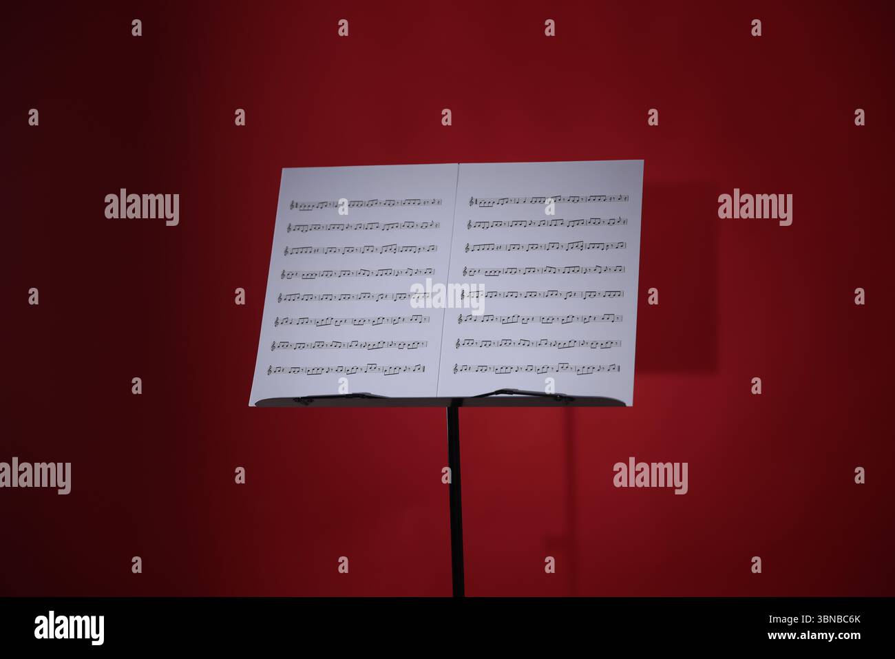 Note stand with music sheets on red background Stock Photo
