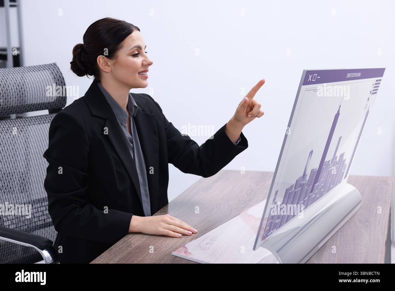 Building information modelling. Woman using virtual screen in office Stock Photo