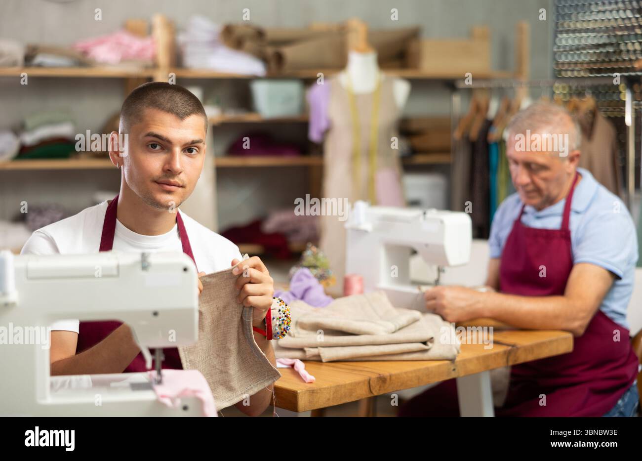 Two male tailors working with fabric Stock Photo