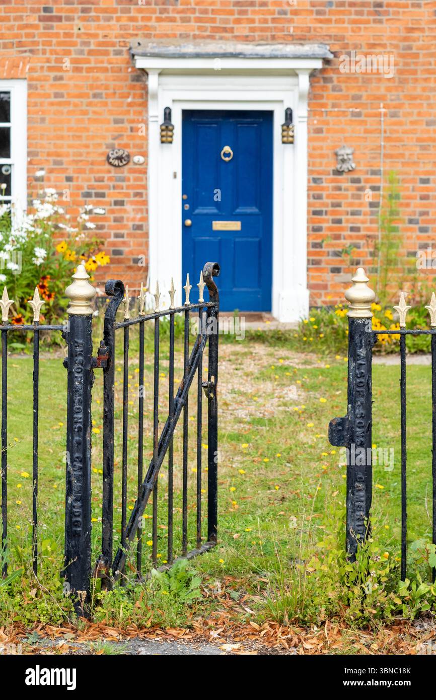 Elegant traditional period property - an elegant Georgian style  brick built house with metal railing and entrance gate in the village of Stock in Ess Stock Photo