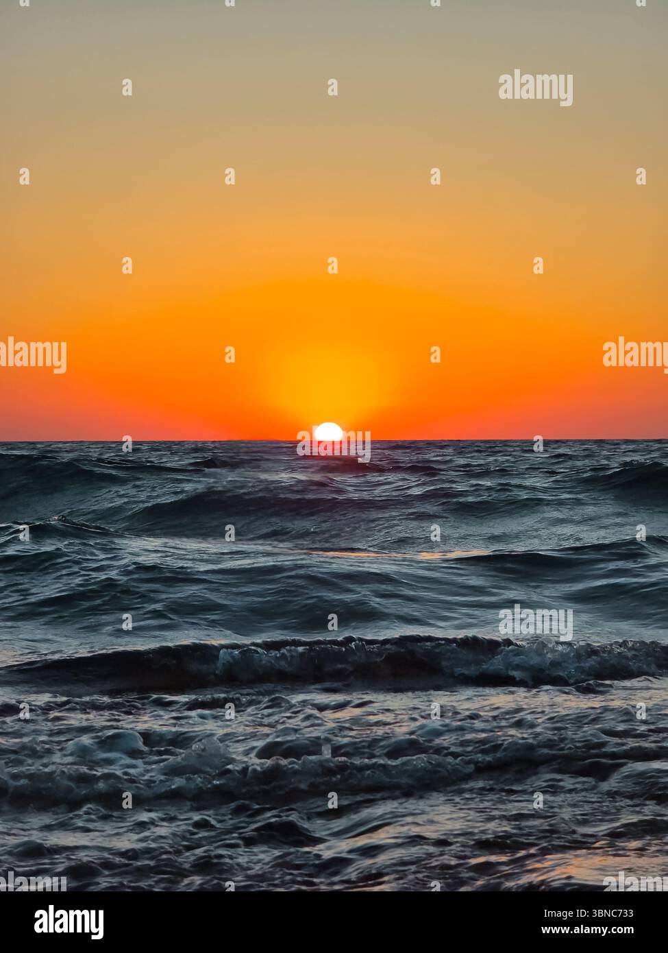 Scenic view of sea against orange sky. View of sea during sunset - Smartphone Captured Stock Image