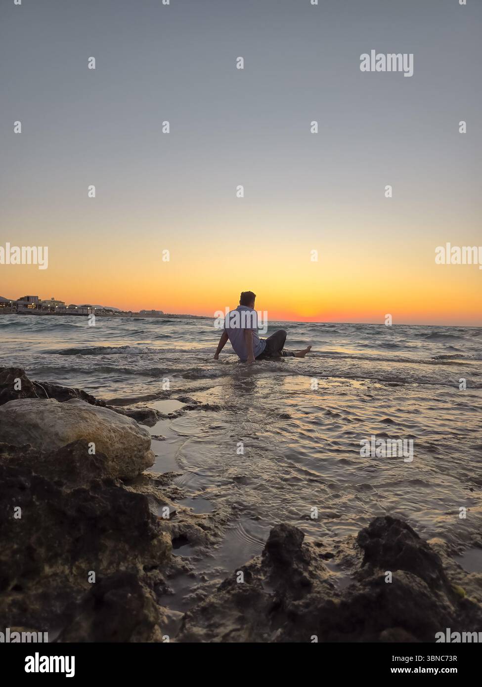 Beautiful sunset with yellow and blue sky over the ocean. - Smartphone Captured Stock Image