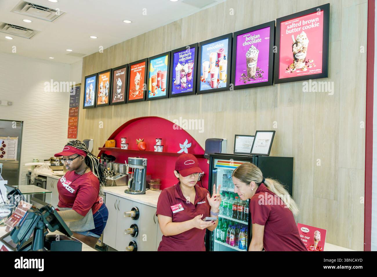 Miami Beach Florida,Lincoln Road pedestrian shopping mall,Haagen Dazs ice cream brand store,inside interior,adult women female employees Hispanic Lati Stock Photo