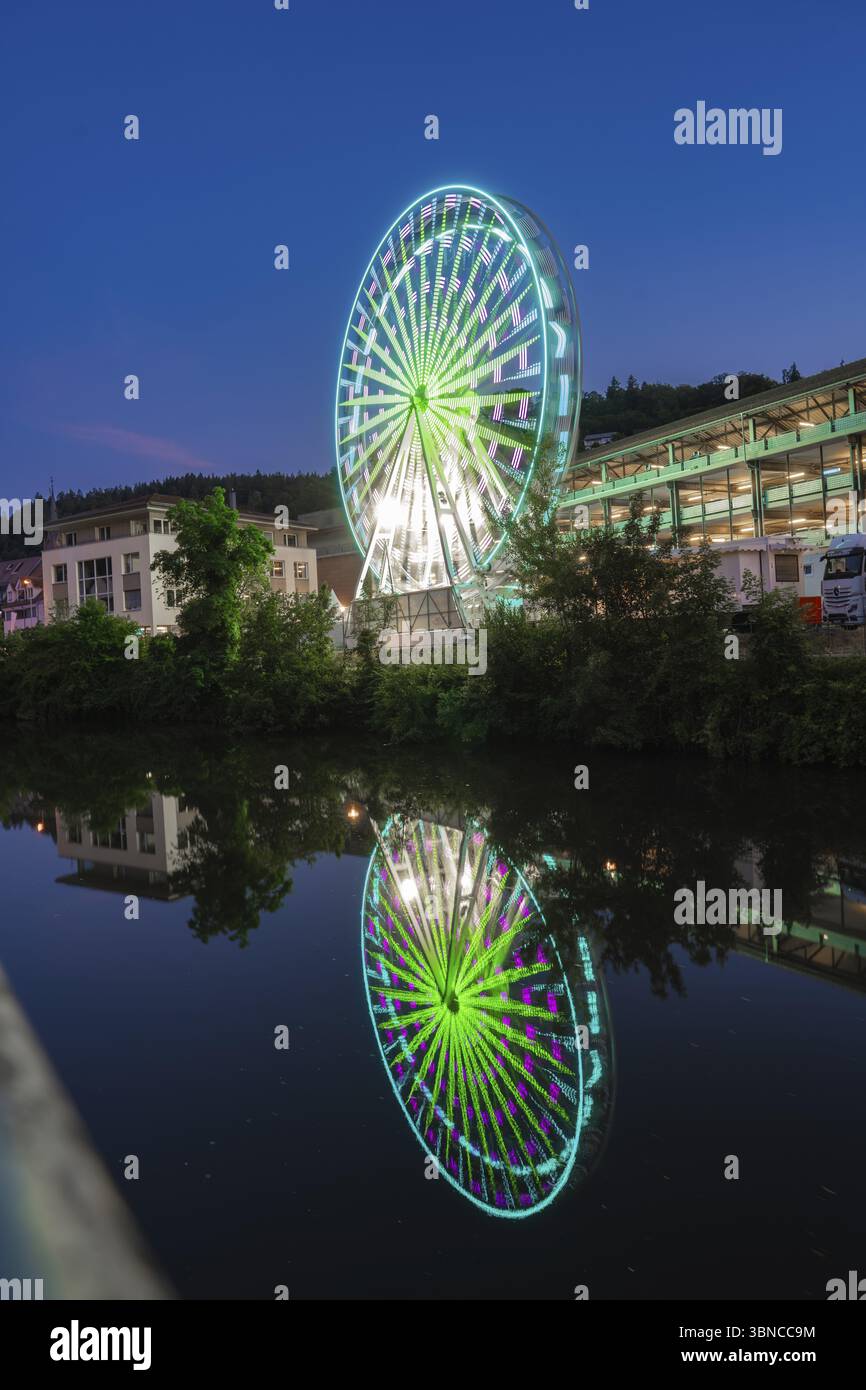 A Red Illuminated Ferris Wheel With Reflection In The River Against A A Red Illuminated Ferris Wheel With Reflection In The River Against A