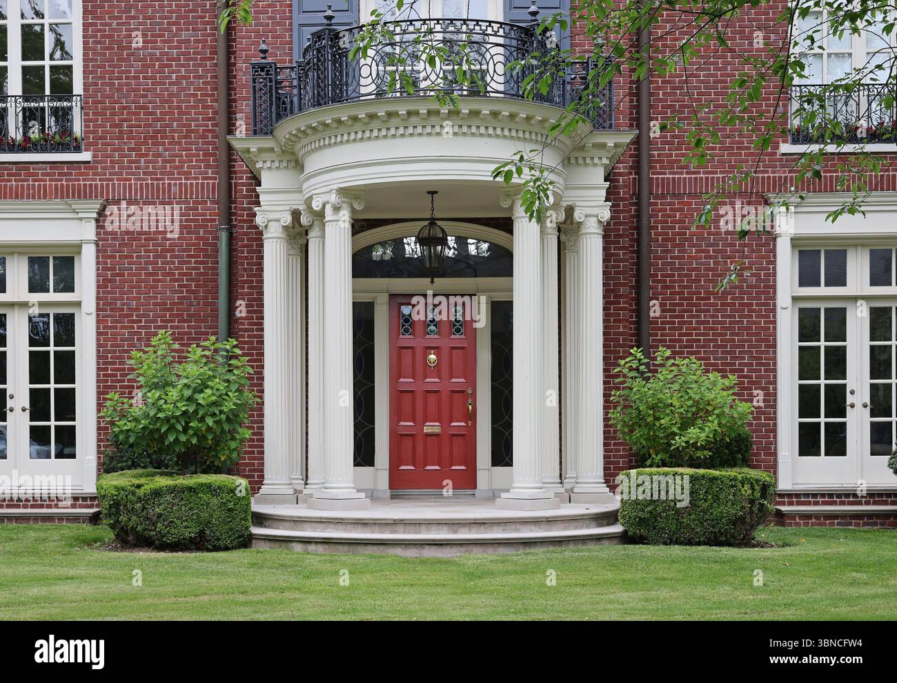 Brick house with elegant portico entrance Stock Photo