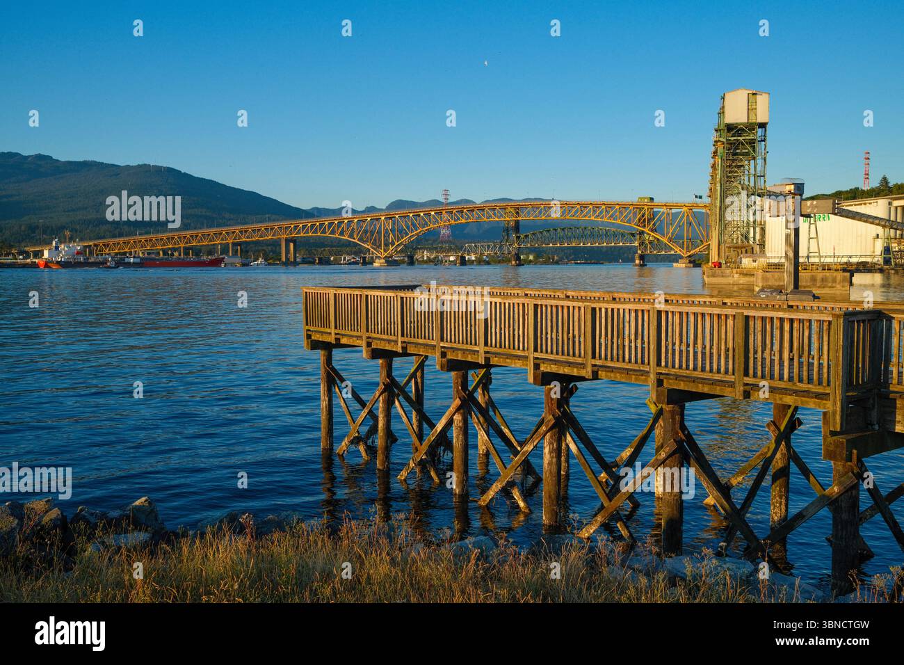 The Ironworkers Memorial Second Narrows Crossing (also known as the Second Narrows Bridge) stretches across to North Vancouver from Vancouver, BC. Stock Photo