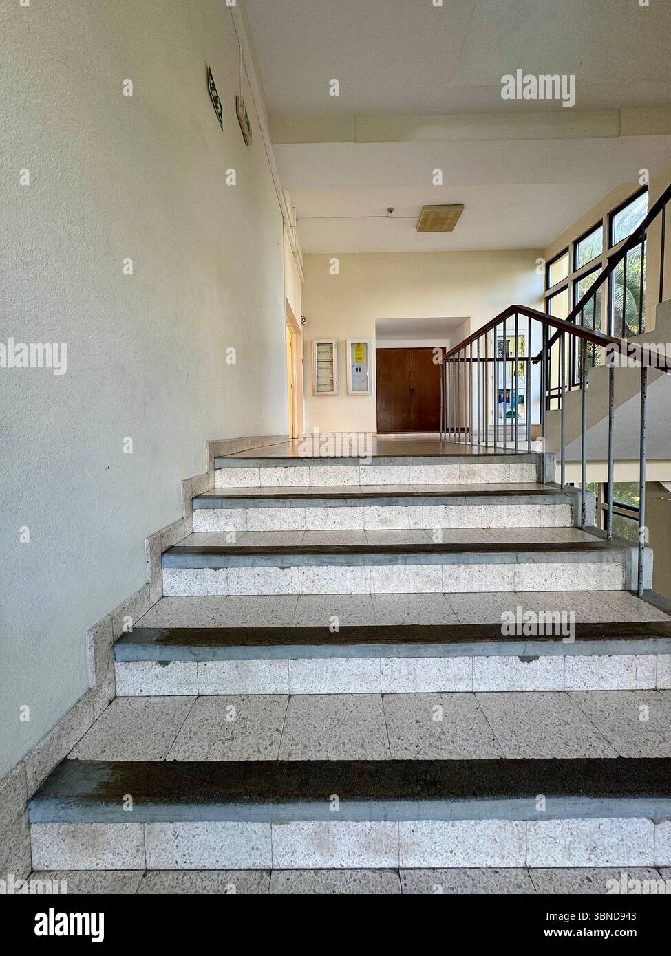 Sunlit interior staircase at Escola Secundária Antero de Quental, Ponta Delgada, Azores, Portugal. - Smartphone Captured Stock Image
