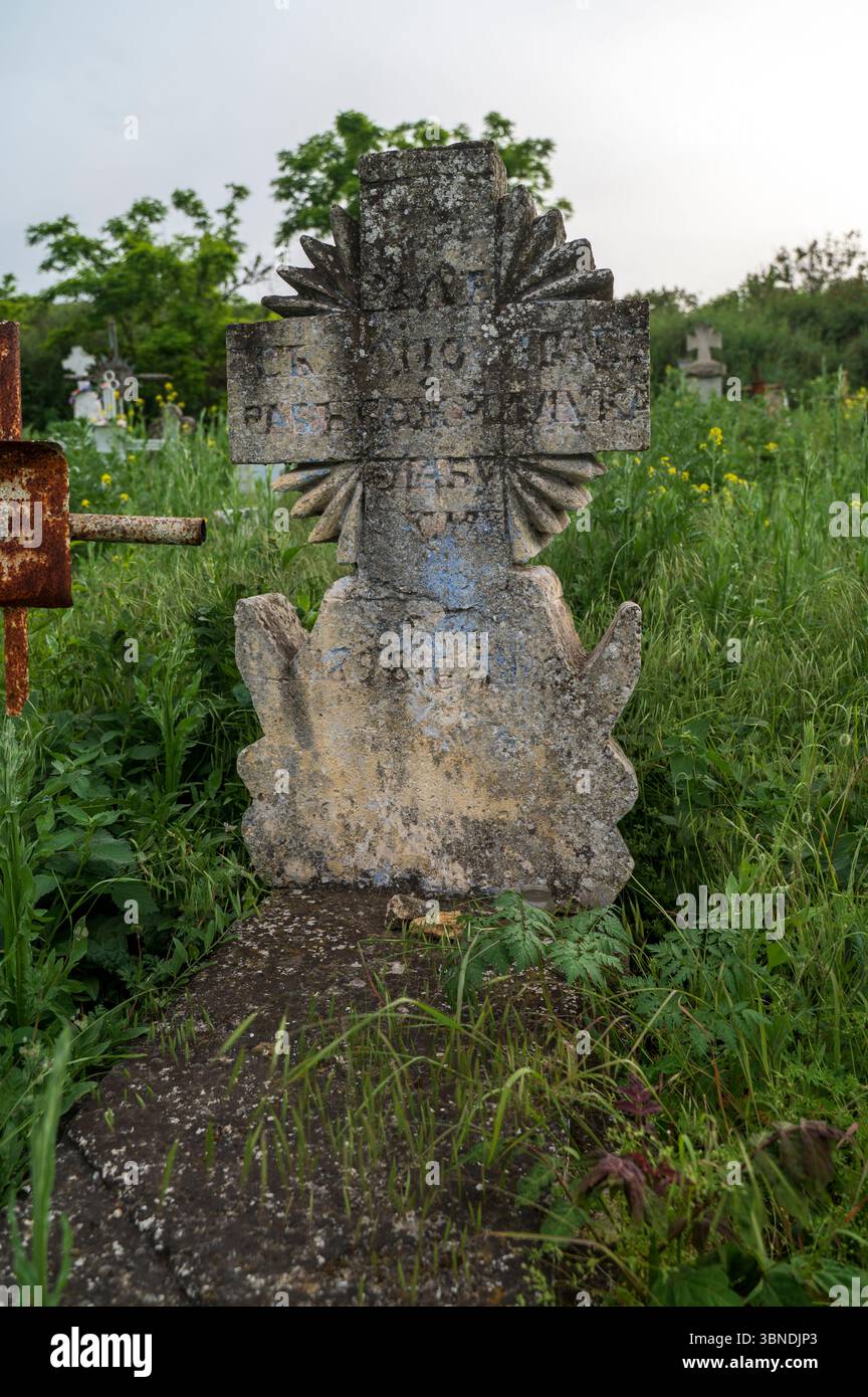Stone cross in an old cemetery. Old stone cross with inscriptions ...